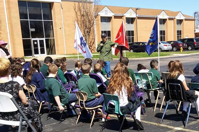 Teaching students about the American flag at Our Lady of the Sacred Heart Acadamy.
