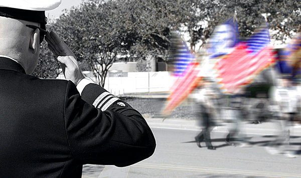 Navy veteran saluting the American flag.