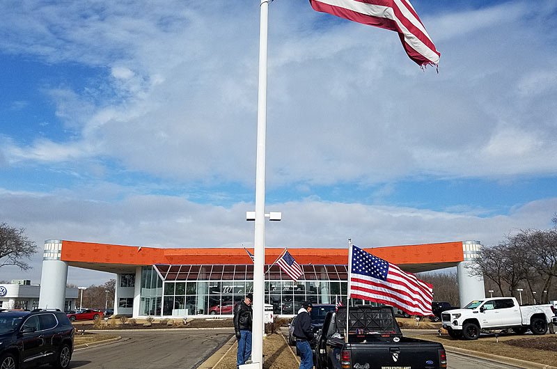 Replacing the flag at Lou Bachrodt Auto Mall