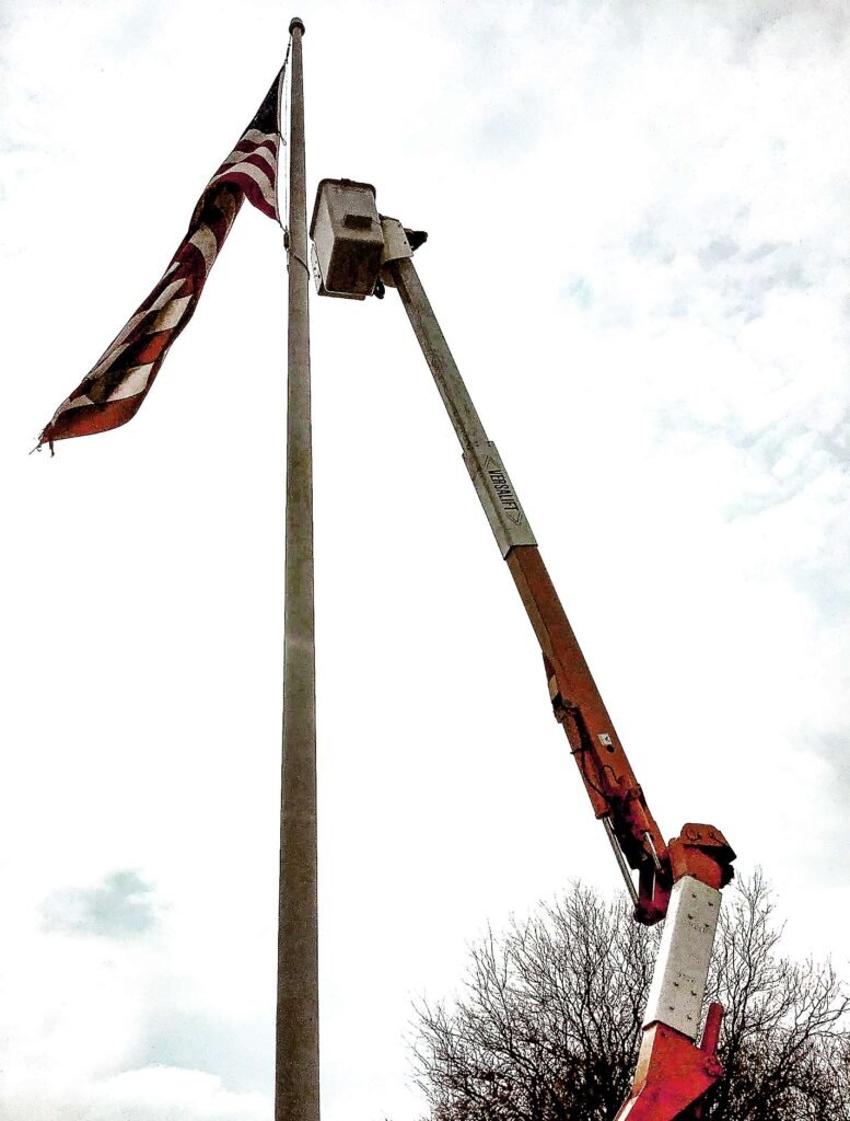 Installing new flag at Lou Bachrodt Chevrolet