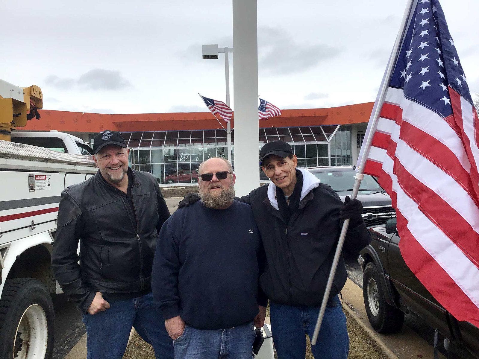 Installing new flag at Lou Bachrodt Chevrolet