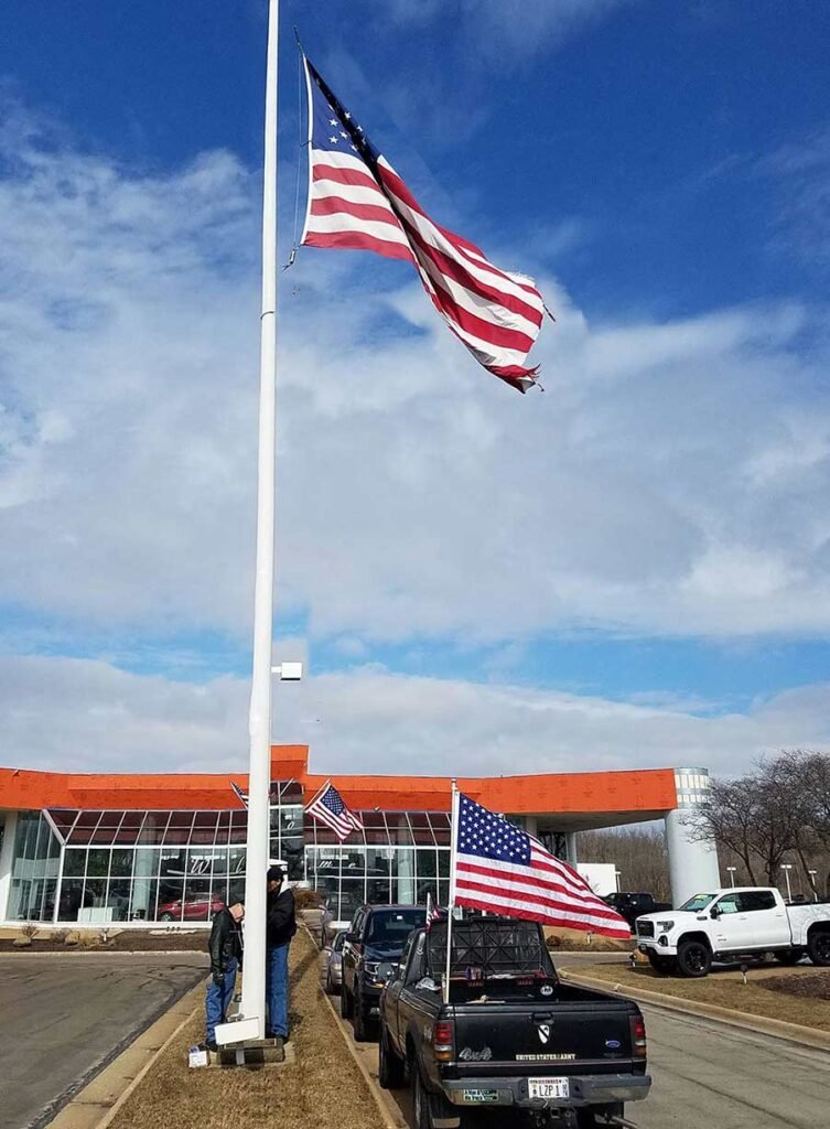 Installing new flag at Lou Bachrodt Chevrolet